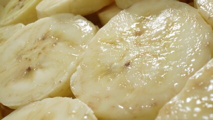 In this intimate view, sliced bananas unveil their luscious interior, boasting a uniform texture with subtle brown flecks at the core. The soft, glossy appearance promises a delectable indulgence.
