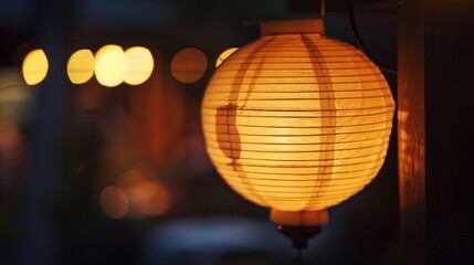 Fototapeta premium Close-up of a traditional paper lantern glowing softly in the dark, creating a serene and tranquil ambiance