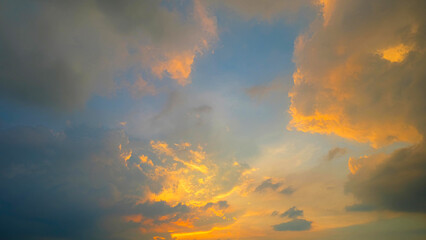 A stunning sunset with dramatic cloud formations. The sky transitions from vibrant shades of orange...