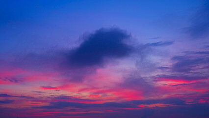 A breathtaking sunrise with deep purples, pinks, and blues blending across the sky. A prominent...