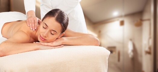 Beautiful young woman relax lies having massage.
