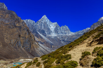 Himalaya mountains landscape with high altitude snow and ice glacier summit peaks. Everest Base Camp Solo Khumbu trekking region in Nepal. Beautiful Himalayas eight thouthander summits under blue sky