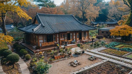 Obraz premium This beautifully captured autumnal image showcases a traditional wooden house with a tiled roof surrounded by a meticulously maintained garden and colorful foliage