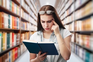 A student stuying reading books in library of university.