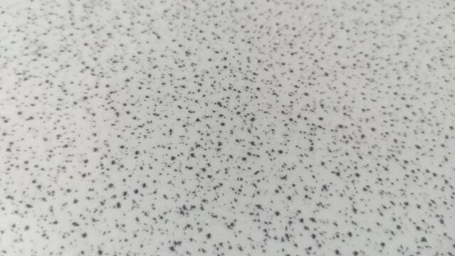 Close-up macro shot of seamless terrazzo pattern of marble mosaic natural concrete floor. Slow-motion.