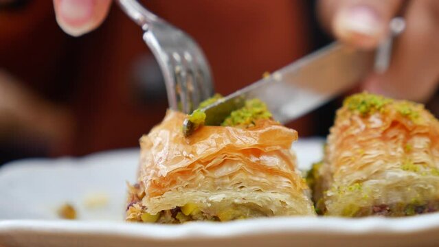  cutting turkish dessert baklava suing knife and fork 
