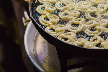 Jalebi or jilipi, being cooked hot in oil for hindu festival of ratha Yatra. It is a traditional...