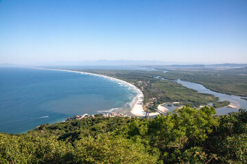 Adventurous climber hangs off Pedra do Telégrafo with breathtaking coastal view in Rio de Janeiro