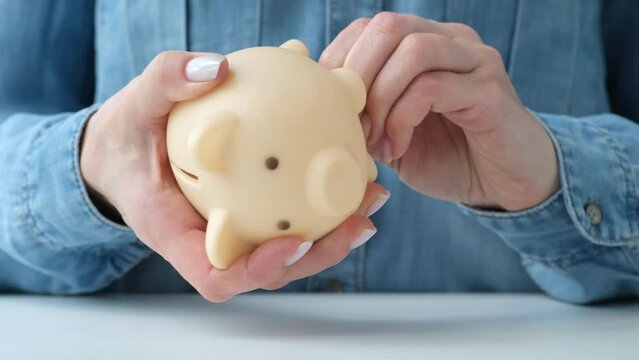 Woman can't open the piggy bank. Bankruptcy of a financial institution or pension fund. Person unable to withdraw money. Deposit and savings insurance