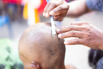 Human head being shaved with a razor