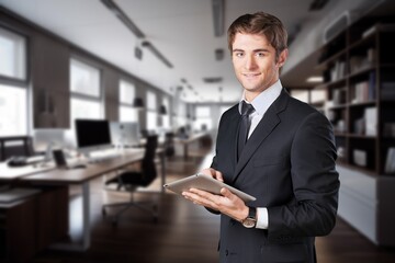 Smiling busy business manager hold tablet computer