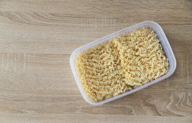 boiled instant noodle in bowl with hot water preparing for cook in menu of day