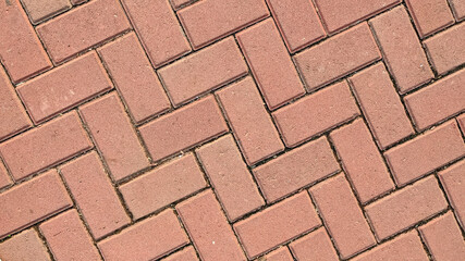 Pattern of red bricks in a walkway.