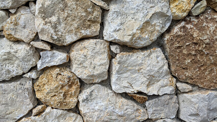 A wall made of large rocks with a brown and white color