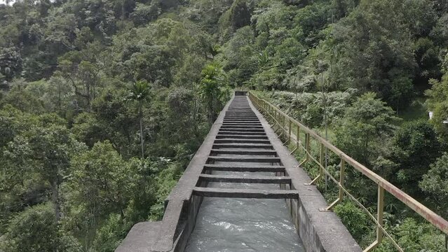 Establish aerial view of the Batu Busuk Hydroelectric Power Plant is one of the villages in Padang City surrounded by forests and rivers d-log raw stock video