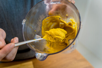 Chef at the kitchen preparing chickpea porridge with ginger