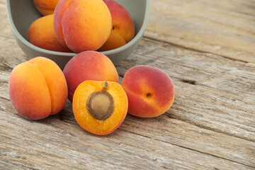 Pile of ripe apricots isolated on rustic wooden table