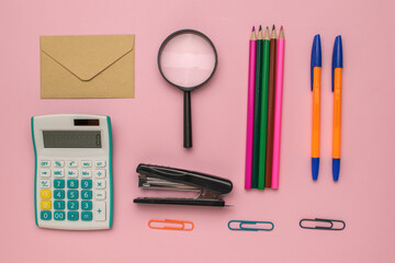 Office Supplies on Pink Background: Calculator, Magnifier, Stapler, Pens, Pencils, Envelope, and...