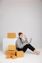 Portrait Asian smart entrepreneur business woman in casual suit surround by parcel boxes service...