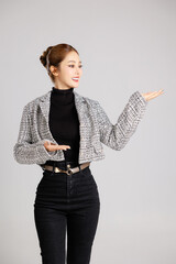 Asian smart happy entrepreneur business woman smile in casual suit gesture imaginary on her palm to...