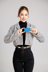 Asian smart happy entrepreneur business woman smile in casual suit gesture showing blank screen...