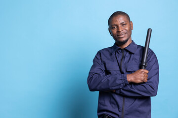 African american security officer feels proud with his duty in studio, posing with confidence...