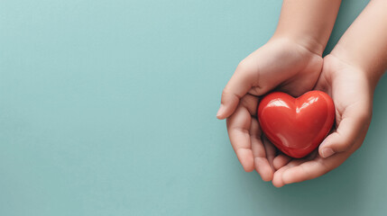 Obraz premium Hands Holding a Red Heart Symbolizing Love and Care