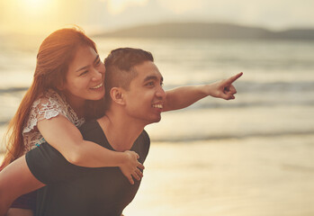 Sunset, piggyback and couple on beach for love, support and together in nature with sunshine....