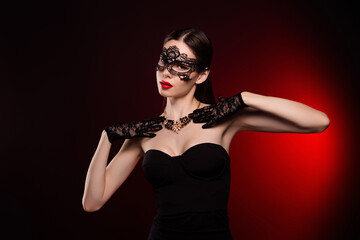 Photo of woman wear black mask dress touch precious pendant on neck isolated red color background