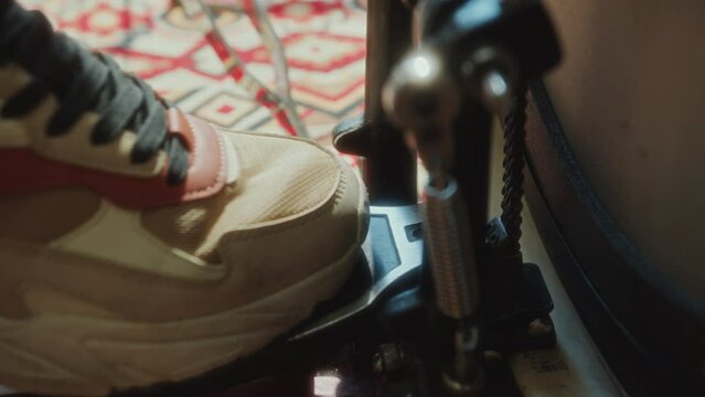 Extreme close-up view of foot of unrecognizable drummer pushing pedal of kick drum during music performance
