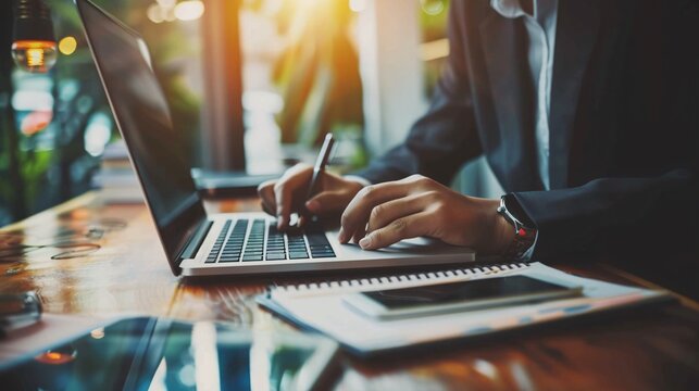 imagine something related with a sales professional, doing a lot of things at the same time, using a laptop, using a cellphone and making some notes on a notebook.