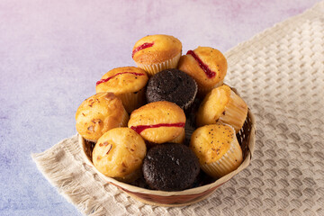 muffins on a table with books and flowers