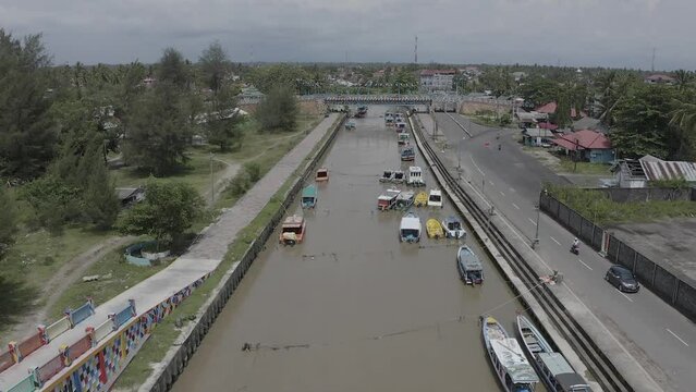 Establish aerial view of the Gandoriah Bridge, a tourist icon located in Pariaman, West Sumatra. Unique bridges have various carvings and colors. d-log raw stock video