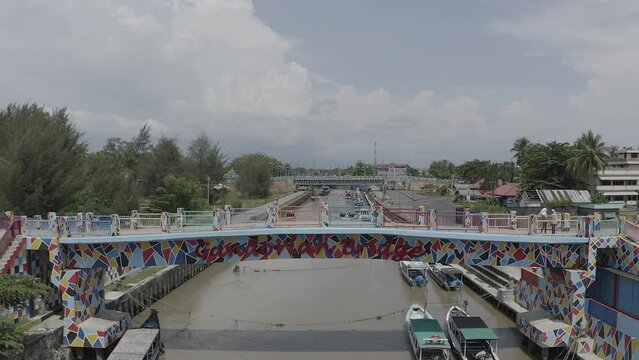 Establish aerial view of the Gandoriah Bridge, a tourist icon located in Pariaman, West Sumatra. Unique bridges have various carvings and colors. d-log raw stock video