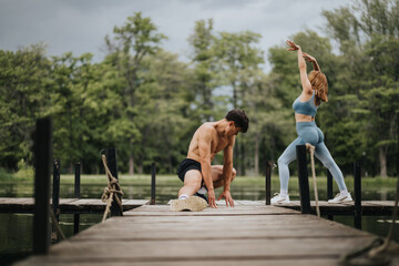 Two people working out on a wooden dock by the lake surrounded by nature. Summer exercise and...