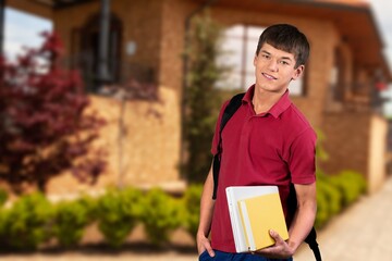 Young happy male student at the university campus.