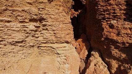Flat rock formation Qarraba peninsula, close up on the cracked limestone where climbers can climb on the top. Ghajn Tuffieha , Qarraba peninsula, aerial close up. High quality photo