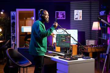 Talented composer artist does a recording session for his acoustic tunes, performing on microphone...