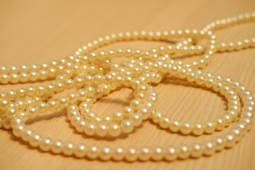 Pearls arranged neatly on a rustic wooden table