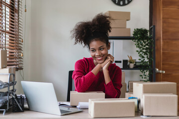 African american women checking online order on laptop with happiness with online shopping business