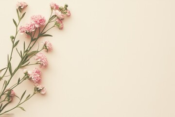 Fototapeta premium Blank paper mock up with a single flower lying diagonally across the corner, set against a clean background with ample copy space, perfect for highlighting text or design.