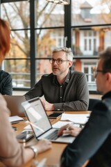 Business owner speaking to employees during team meeting
