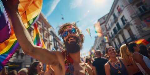 Man with beard holding rainbow flag