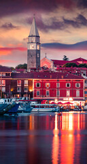 Splendid sunset of old fishing town town Isola. Colorful spring evening on Adriatic Sea. Beautiful...