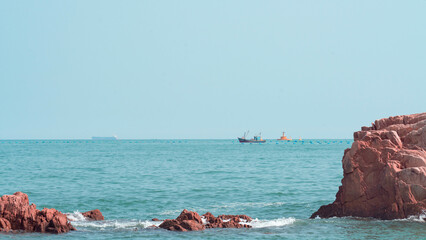 Fototapeta premium Red rocks in the sea