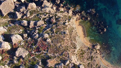 Qarraba Bay flat rock cape Malta, Aerial establishing shot in the morning sunlight. High quality photo