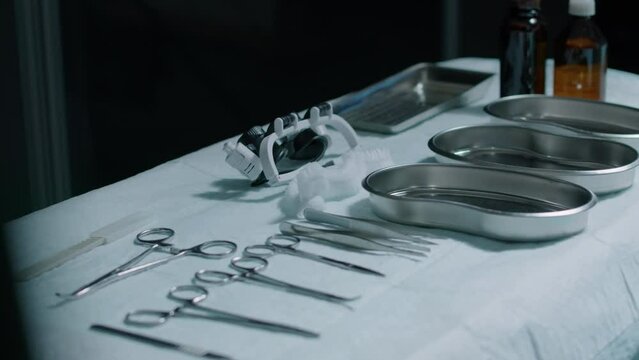 No people shot of sterile stainless steel surgical instruments and tools including scissors and forceps on table in operating room