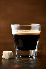 Coffee in glass cup on dark background. Close up. Copy space