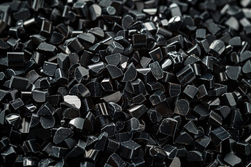 Obraz premium Black plastic granules for a color background, plastic rubber granule stove material, winner of a stock photo contest, a photo of black plastic, plastic, and mechanical. A solid black background, phot