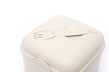 Plastic food container with built-in fork and gravy boat.